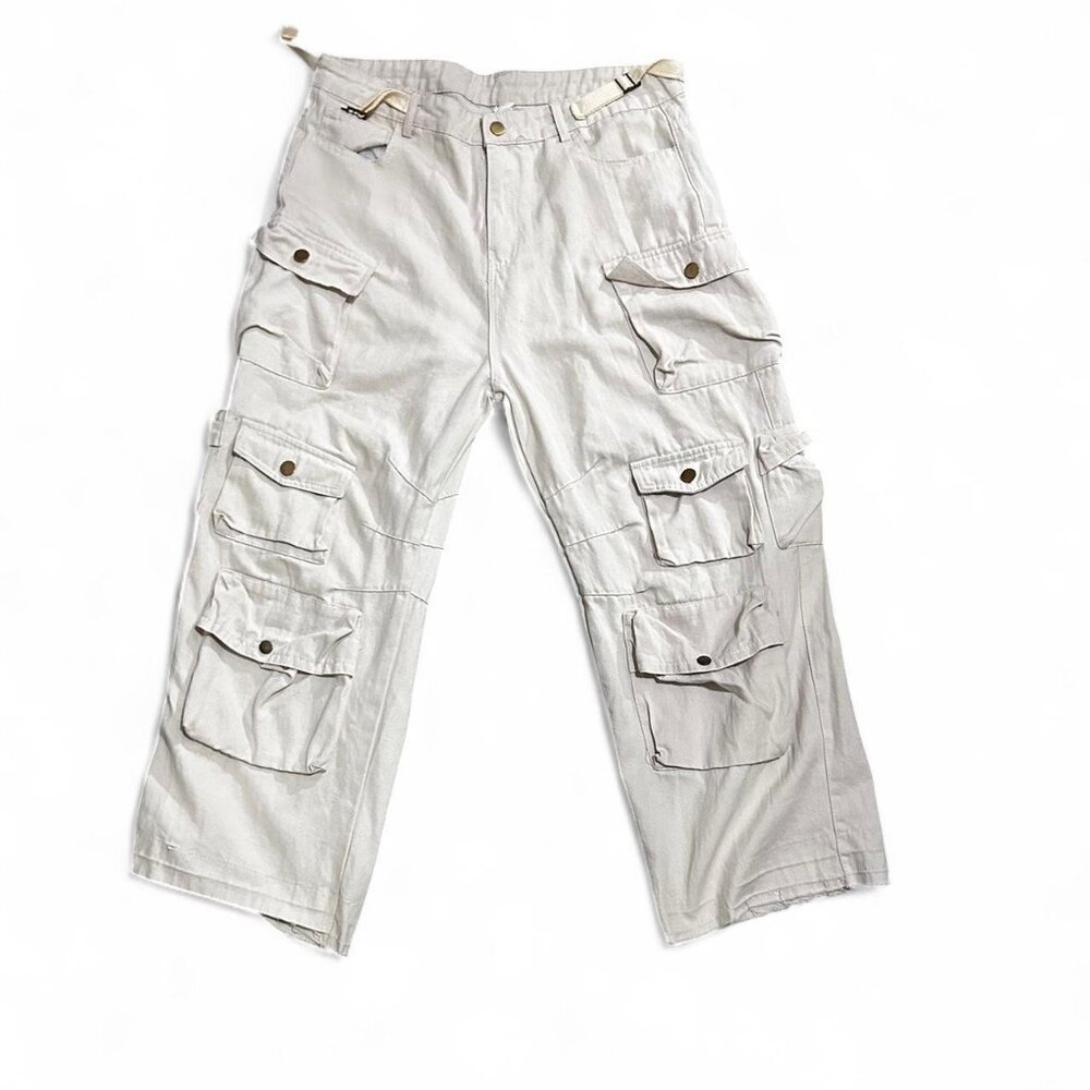 Cream cargo pants with adjustable waistband, multiple pockets, and a relaxed fit